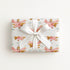 Girl airplane wrapping paper featuring two little pilots flying in a pastel pink vintage biplane.