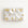 Wrapped gift in vintage-inspired airplane wrapping paper featuring a little girl flying a yellow and gold biplane over a delicate navigation map with gold accents on an ivory background, tied with a white satin bow.