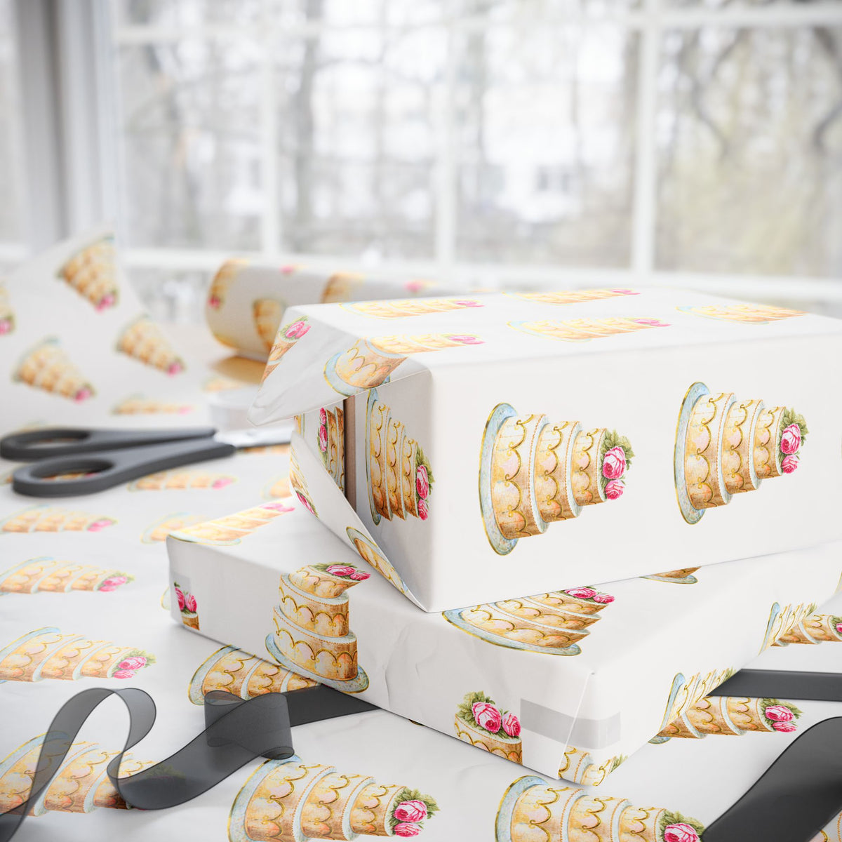 Stacked wedding gifts wrapped in ivory wedding cake wrapping paper on a wrapping table with scissors and sheer ribbon