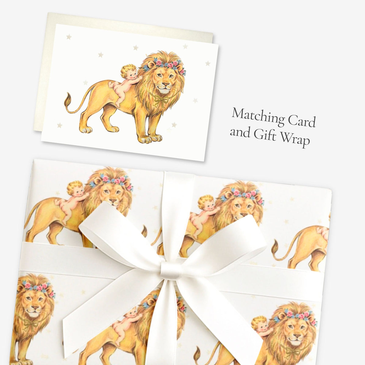 Lion baby shower card shown with matching vintage-inspired lion and baby gift wrap tied with a white satin bow