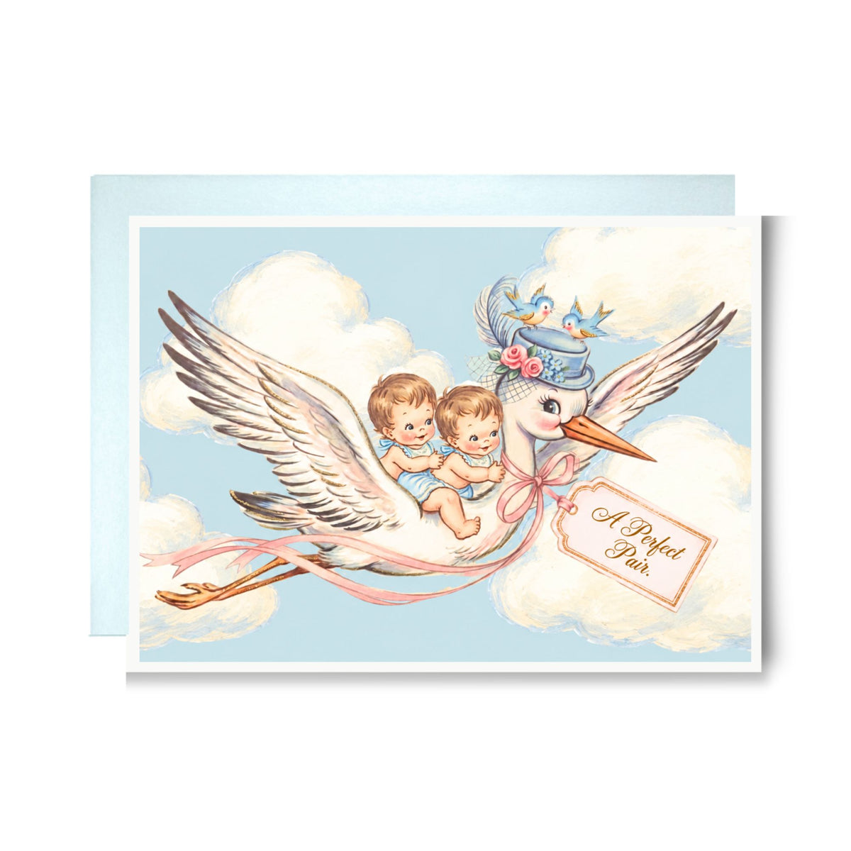 New twin boys card with a stork in a flower-trimmed hat carrying two baby boys in blue through the clouds, with bluebirds and an A Perfect Pair tag