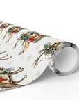 A roll of Christmas wrapping paper featuring a repeating pattern of babies atop reindeer with red scarves, green wreaths, colorful string lights, and light gray snowflakes on a white background.