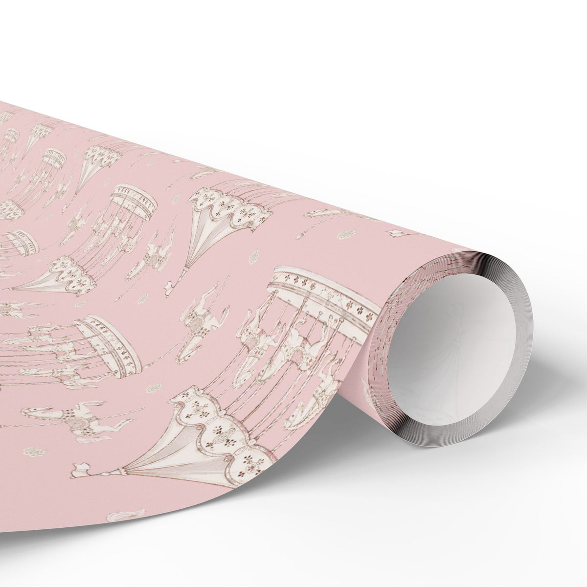 A roll of pink wrapping paper featuring a delicate vintage illustration pattern of carousel horses, shown partially unrolled on a clean white background.