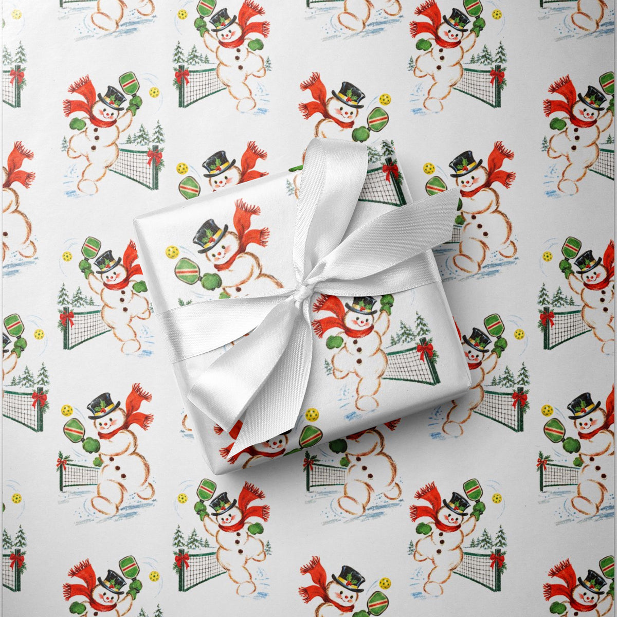 Close-up of retro snowman pickleball Christmas gift wrap showing a snowman playing pickleball.