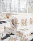 Ivory wrapping paper with a vintage carousel print, shown wrapped around gift boxes on a table with scissors and ribbons in front of a softly blurred window.