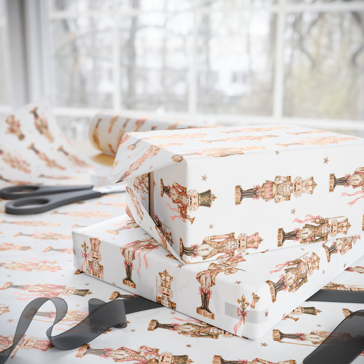 Stacked Christmas gifts wrapped in vintage-style pink nutcracker wrapping paper on a wrapping table with scissors and black ribbon