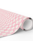 A roll of wrapping paper with a pink and white gingham pattern, shown partially unrolled on a clean white background.