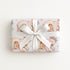 Small gift wrapped in polar bear hug baby boy gift wrap with a white bow, winter baby shower gift