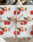 Hands holding a Christmas gift wrapped in vintage-style patriotic angel wrapping paper with a copper striped ribbon bow