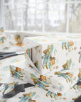 Gift-wrapping paper with a storybook illustration of a bride and groom kissing midair in their biplane.