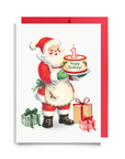 Vintage-style Santa holding a Happy Birthday cake with a number one candle beside wrapped gifts, Santa first birthday card