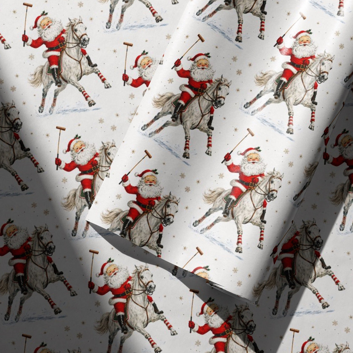 Christmas wrapping paper with a repeating vintage style illustration of Santa Claus riding a polo pony, shown with one roll partially unrolled over the other.