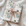 Gift wrapped in vintage-style Christmas wrapping paper with snowmen beside a blue baby carriage and a champagne satin ribbon, snowman baby boy gift wrap