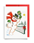 Vintage-style snowman in a top hat and red scarf swinging a green striped pickleball paddle at a yellow ball beside a snowy net, snowman pickleball Christmas card