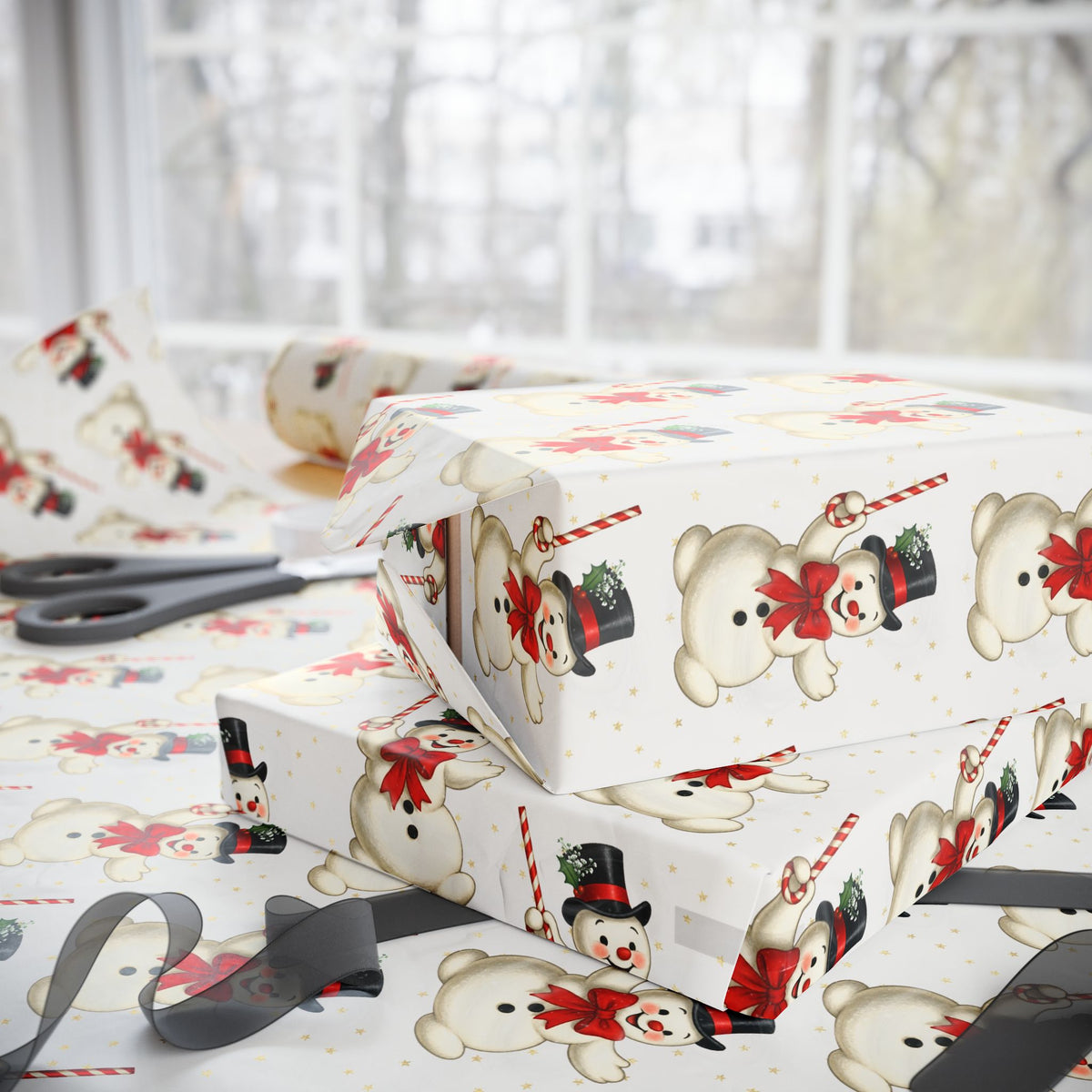 Ivory wrapping paper with a repeating pattern of vintage illustrated snowmen, styled on a table with scissors and gift boxes in a bright room.