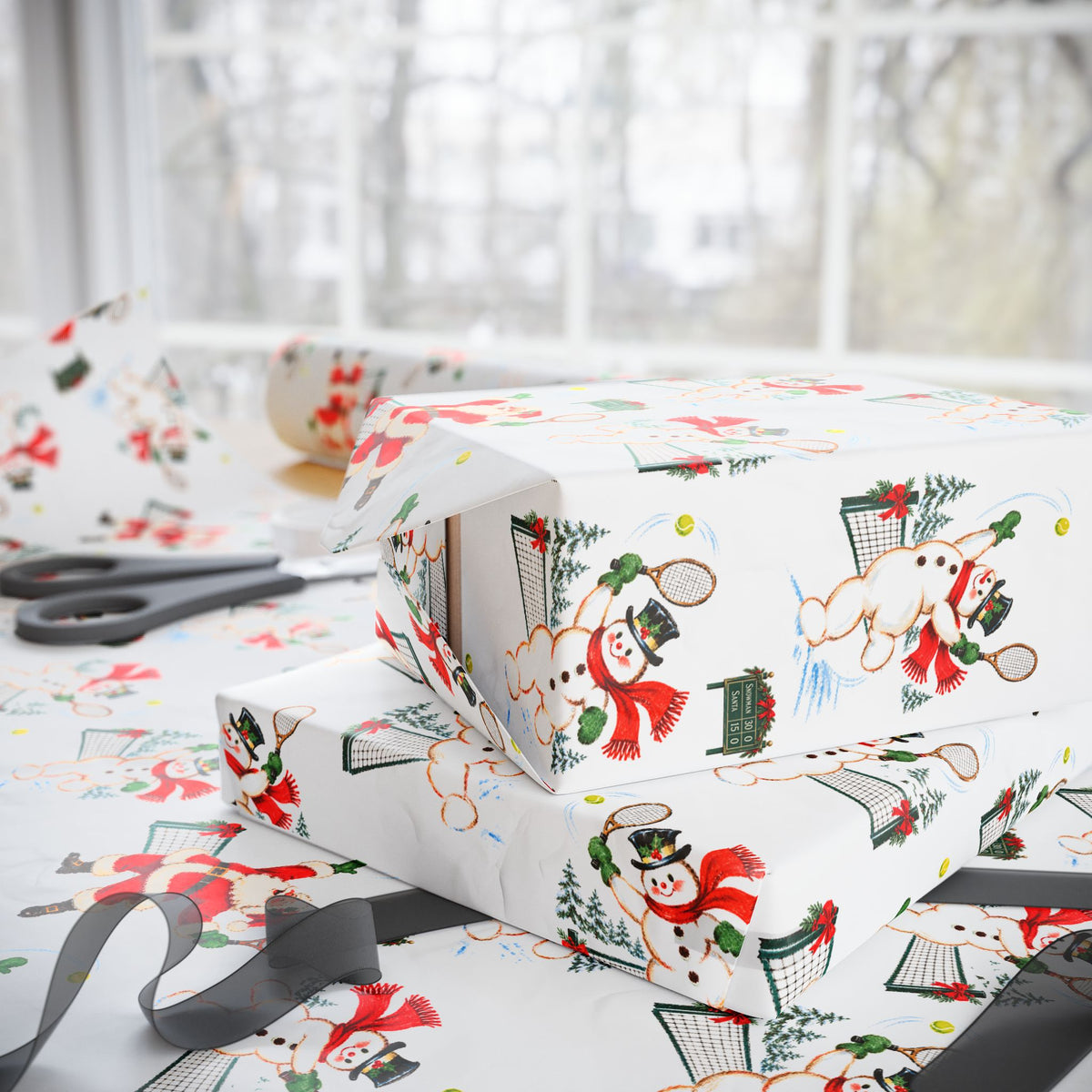 Stacked Christmas gifts wrapped in vintage-style Santa and snowman tennis wrapping paper on a wrapping table with scissors and black ribbon