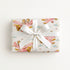 Twin girl airplane wrapping paper featuring two little aviators flying in a pastel pink vintage biplane.