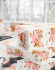 Gift wrap featuring vintage-style twin girls piloting a airplane on a light background.