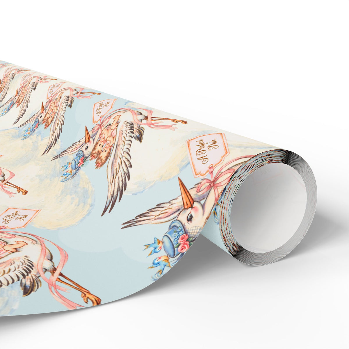 Roll of twin girls stork wrapping paper showing storks in blue clouds with pink ribbons