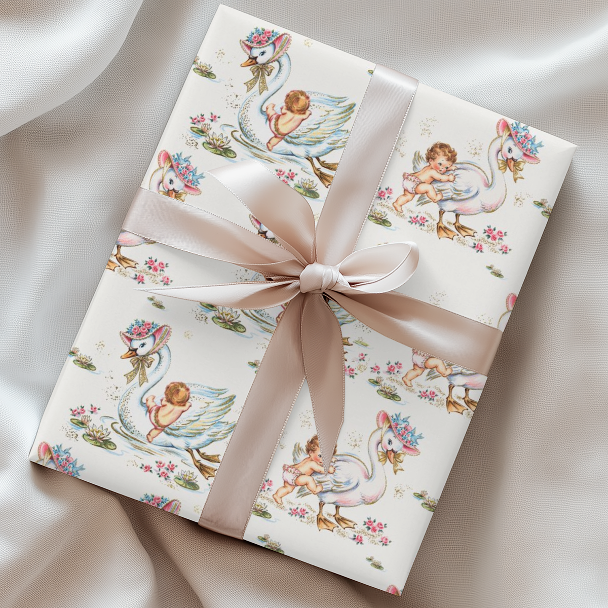 Gift wrapped in vintage-style swan and baby patterned paper with a  satin ribbon.