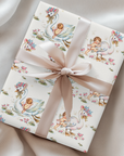 Gift wrapped in vintage-style swan and baby patterned paper with a  satin ribbon.