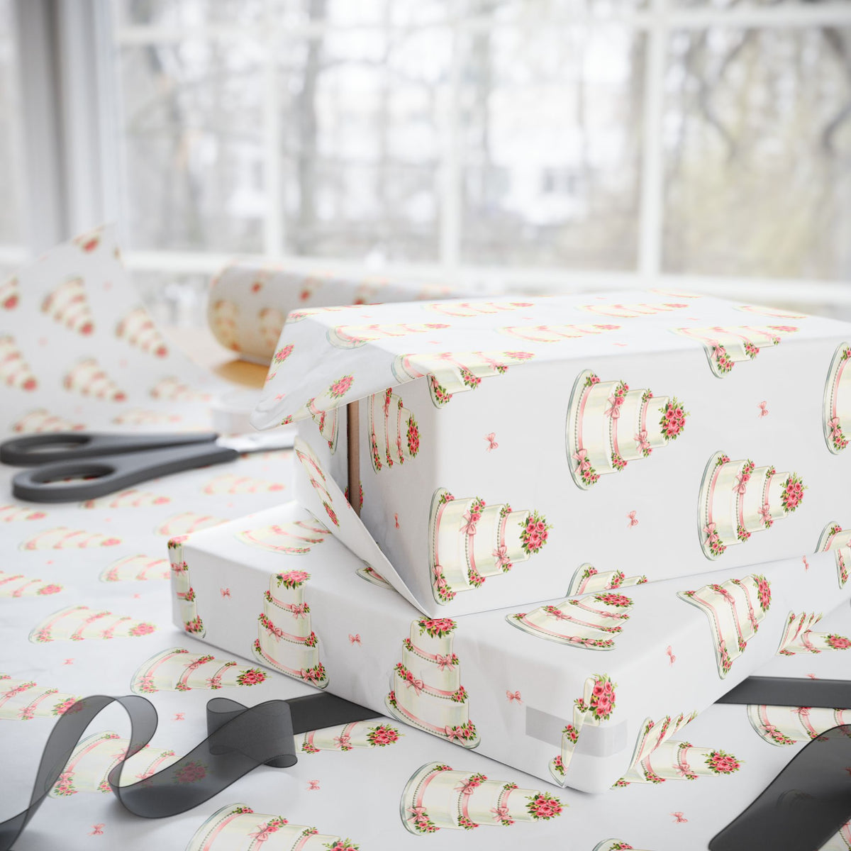 Stacked wedding gifts wrapped in minimalist wedding cake wrapping paper on a wrapping table with scissors and sheer ribbon