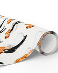 A roll of wrapping paper with a vintage illustration pattern featuring bride and groom kissing.