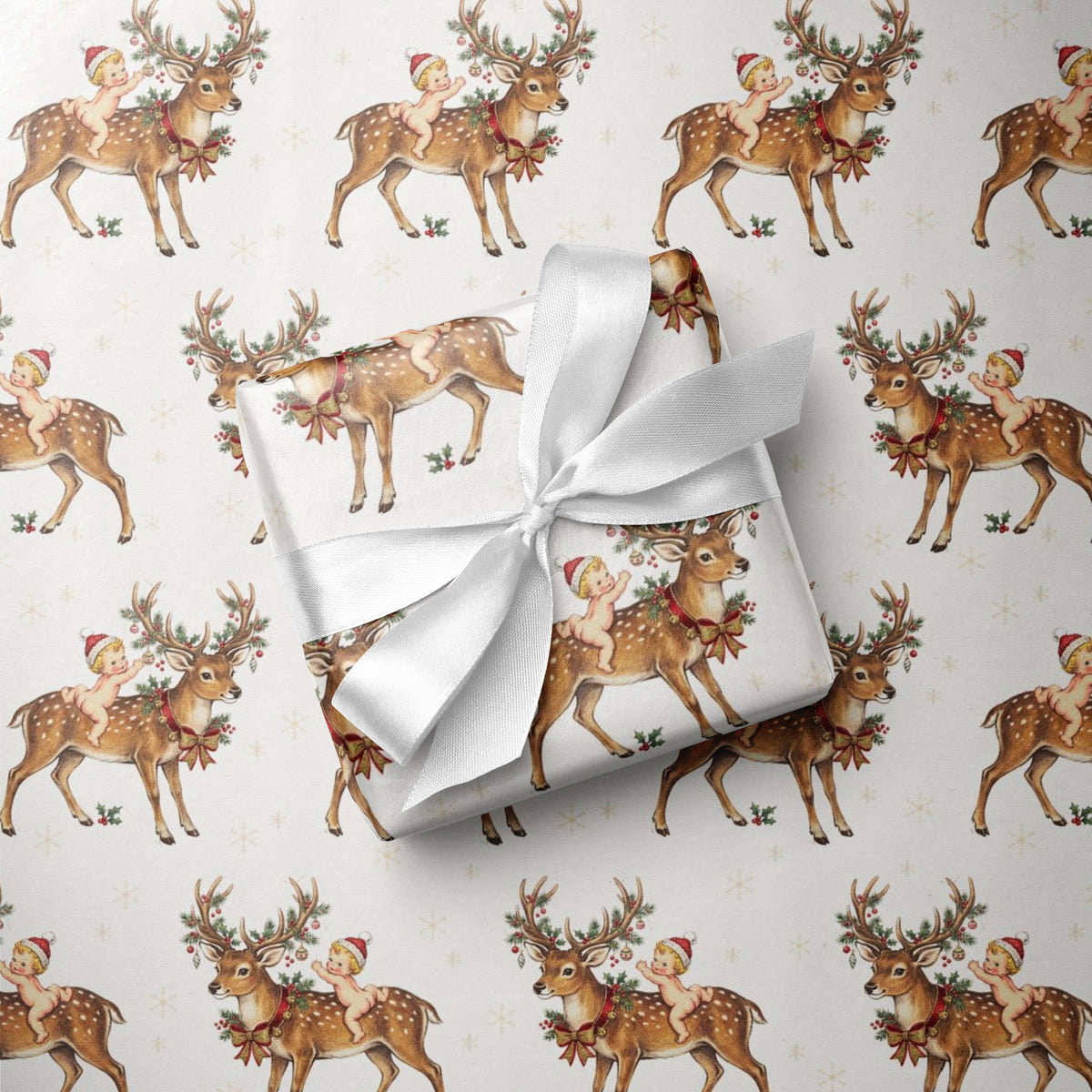 Christmas and winter baby shower wrapping paper roll with repeating baby and reindeer illustration.